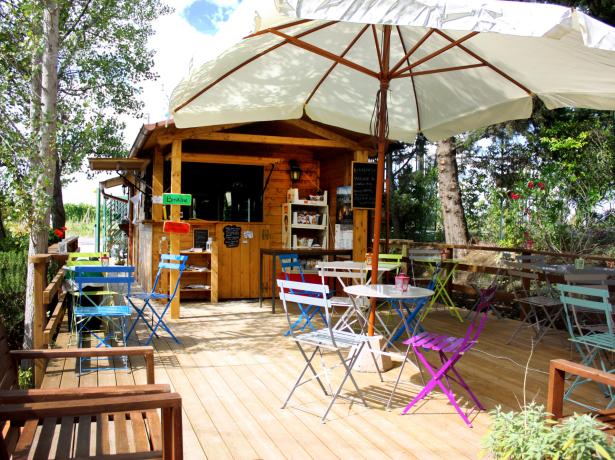 Outdoor café with colorful chairs and umbrellas.