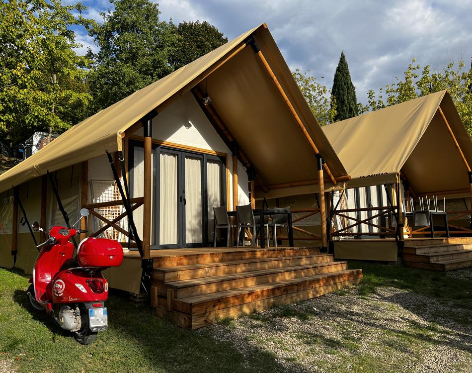 Interior of a glamping tent with dining table and modern chairs.